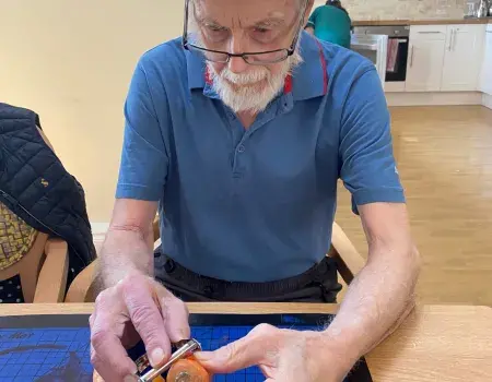 Here is one of our residents peeling a carrot.