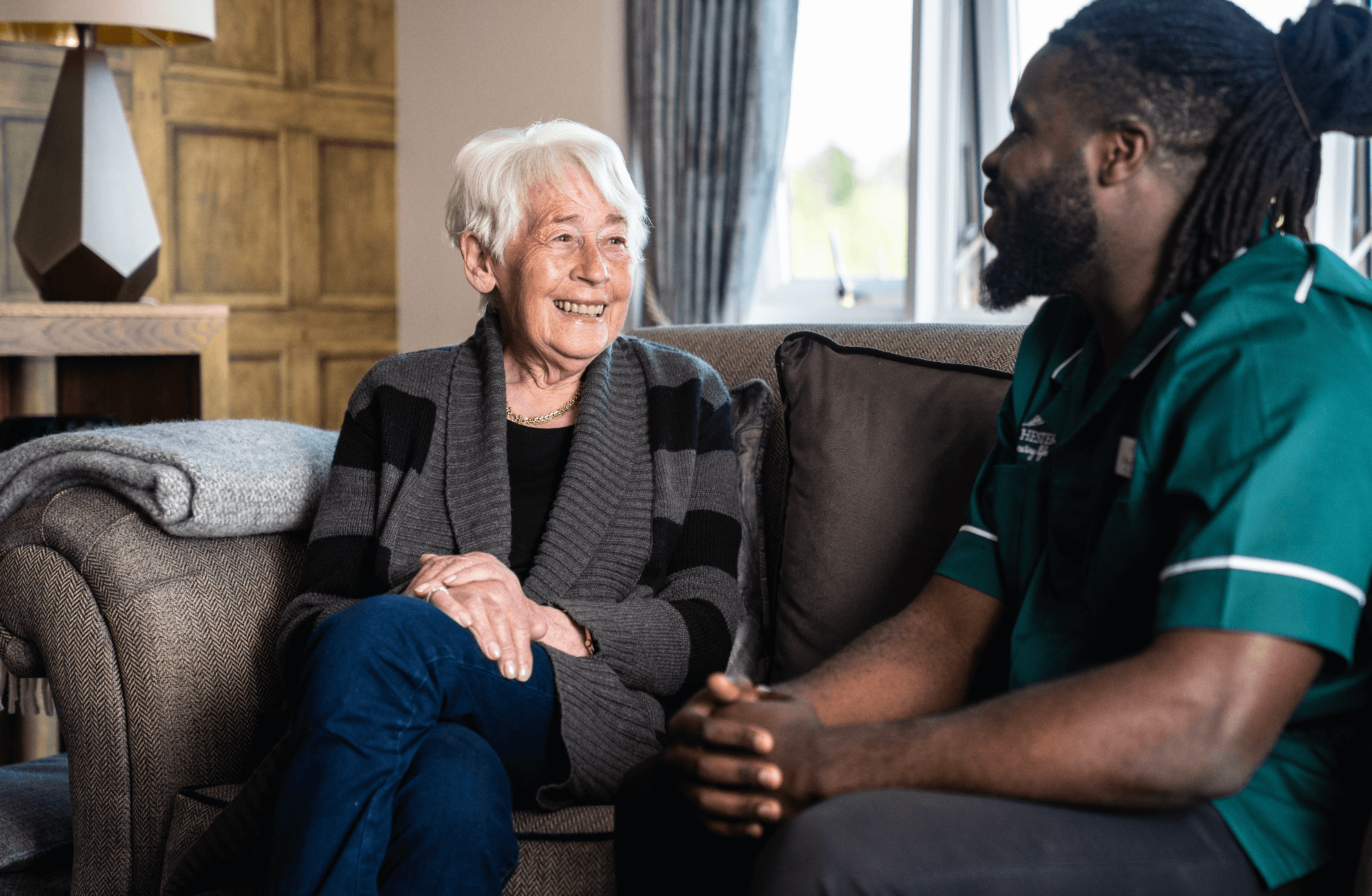 Barchester Nurse speaking to a care home resident