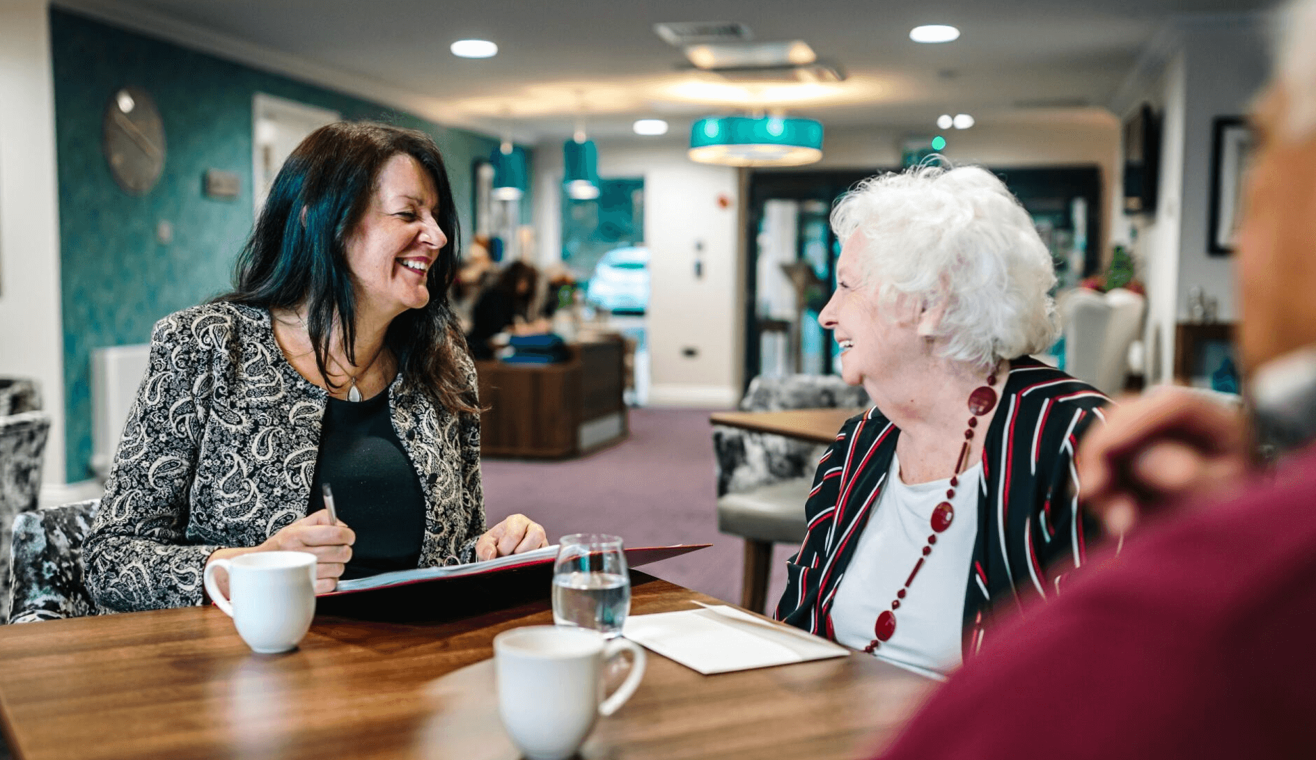 A professional discussing deferred payment agreements for elderly care