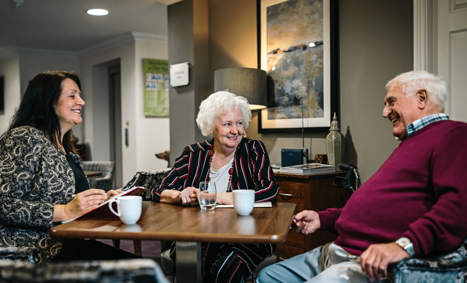 A professional discussing alternatives to deferred payment plans with an elderly couple