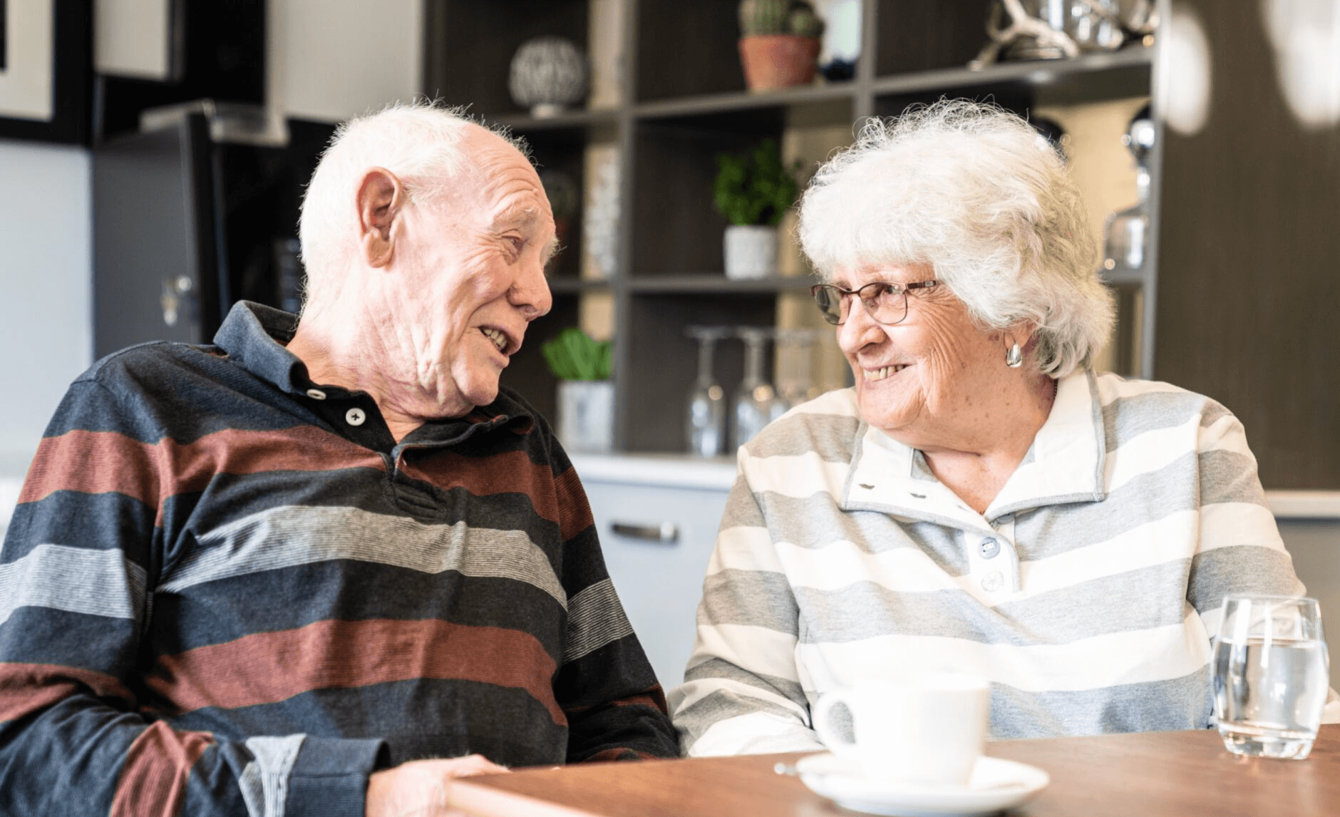 An elderly couple discussing deferred payment plans