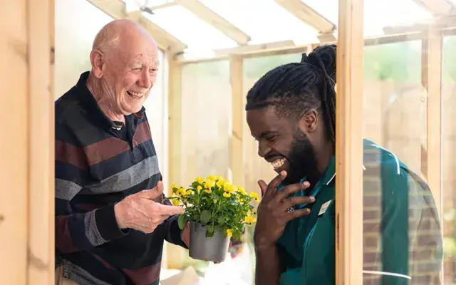 An elderly gentleman and carer in Residential care