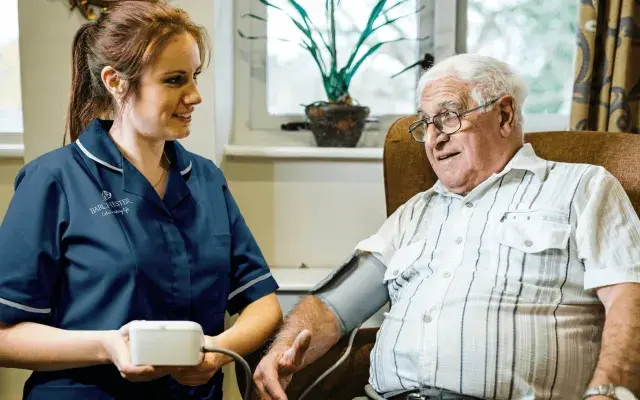 A nurse and resident at a Barchester Nursing Care Home